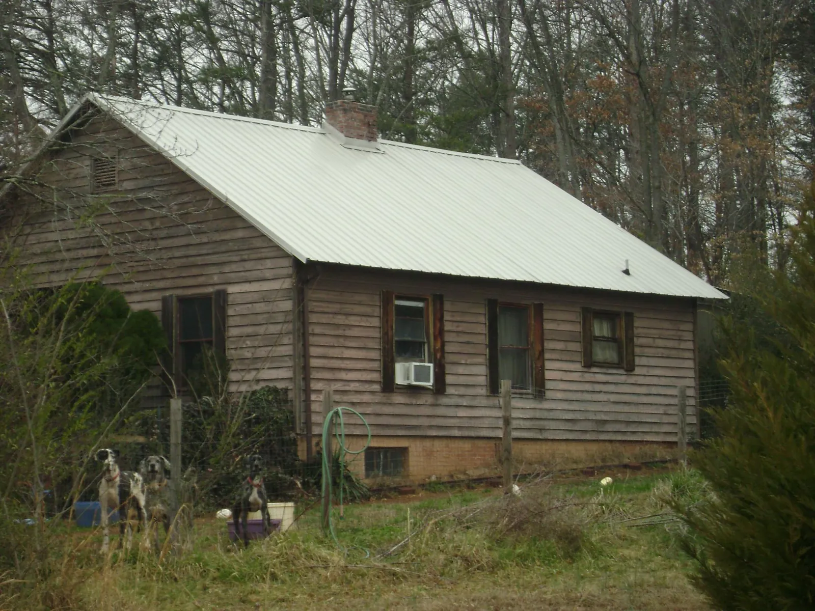 White metal roof on an old wood sided farmhouse, from a Metal Roof Installation job in Mount Marion